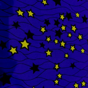 Op de afbeelding: Een stofpatroon met een diepblauwe achtergrond en dunne, horizontale golvende zwarte lijnen. Verspreid over het oppervlak bevinden zich talloze vijfpuntige sterren in afwisselend effen zwart en felgeel, wat een dicht hemels ontwerp creëert.