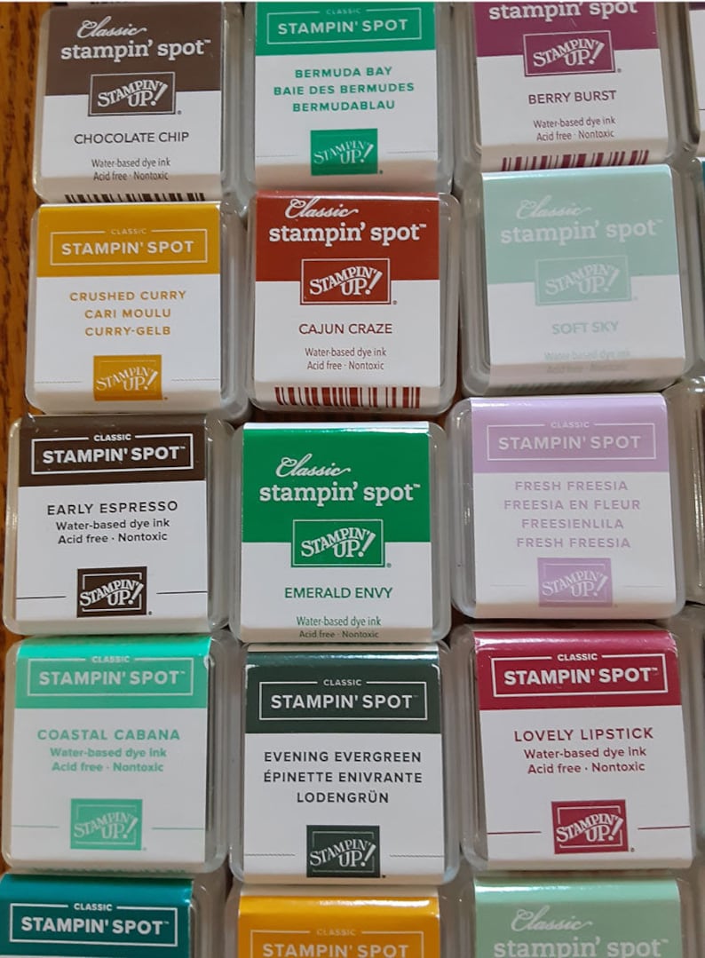 May include: A collection of 12 Stampin' Up! Classic Stampin' Spot ink pads in various colors. Each pad features the Stampin' Up! logo and the name of the ink color. The ink pads are arranged in a grid pattern.