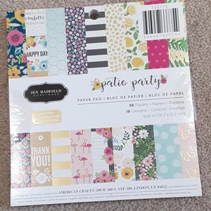 May include: A paper pad titled "Patio Party" with various patterned papers. Designs include floral, flamingo, and geometric patterns. The pad contains 36 sheets, each measuring 6x6 inches (15.2 x 15.2 cm).