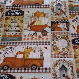 May include: A patchwork fabric design featuring a fall theme with pumpkins, birds, and houses. The fabric has a plaid background and includes the text "Gather Together" and "Welcome Fall".