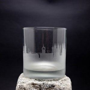 a glass sitting on top of a rock