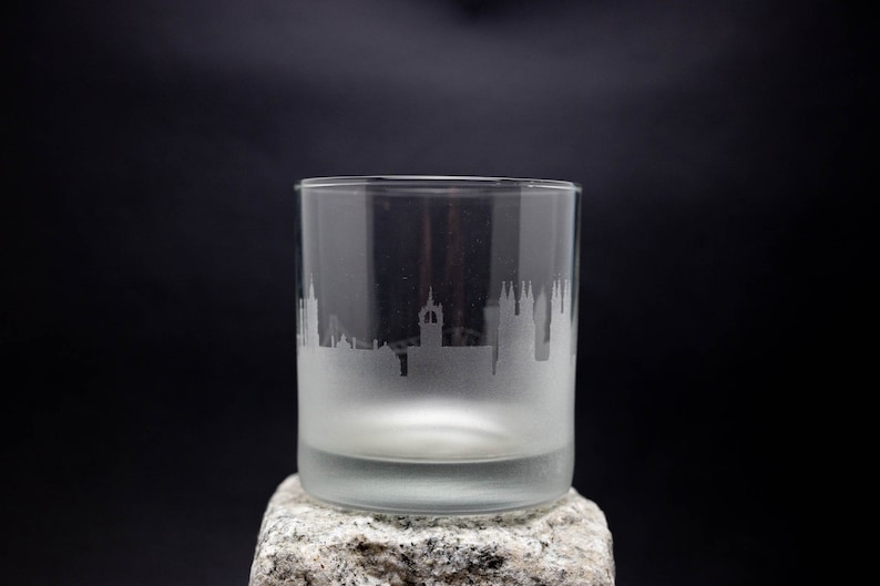 a glass sitting on top of a rock