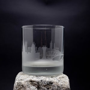 a glass sitting on top of a rock