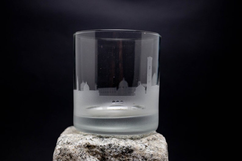 a glass sitting on top of a rock