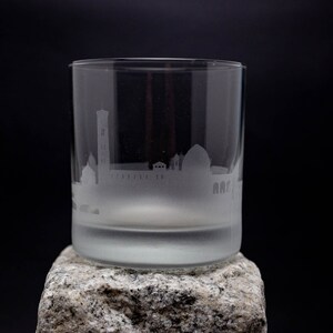 a glass sitting on top of a rock