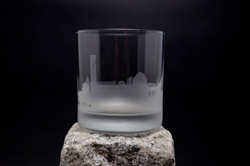 a glass sitting on top of a rock