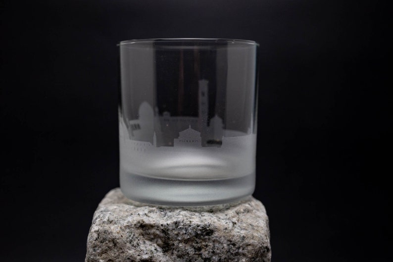 a glass sitting on top of a rock