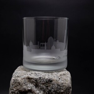 a glass sitting on top of a rock