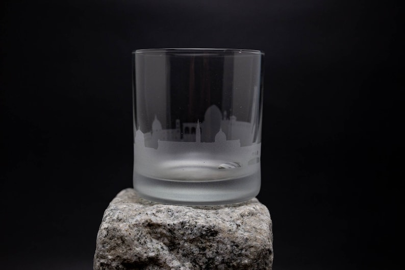 a glass sitting on top of a rock