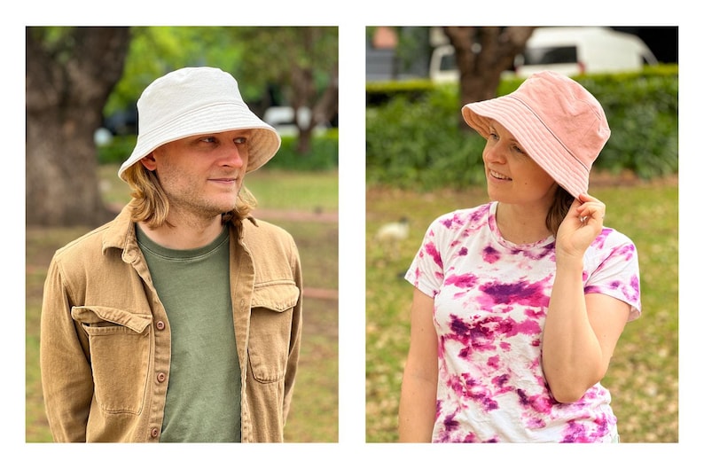 May include: Two people wearing bucket hats. One person is wearing a white bucket hat and a brown jacket. The other person is wearing a pink bucket hat and a tie-dye shirt.