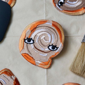 Cinnamon Roll with Eyes 3" Iron On Patch - Dessert Club Frosted with Icing Cinnamon Bun Sweet Patch