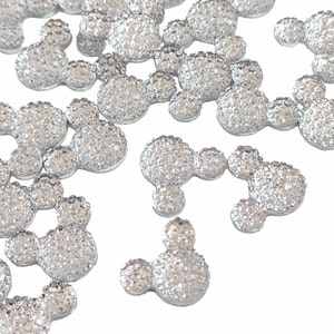 May include: A scattering of silver glitter Mickey Mouse head shaped embellishments.