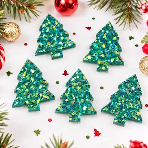 May include: Six glittery green Christmas tree ornaments with a sparkling, textured surface. The ornaments are arranged on a white surface with festive decorations, including red and gold baubles, and pine branches.