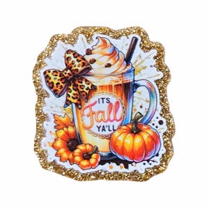 May include: A fall-themed illustration featuring a pumpkin spice latte with whipped cream, a leopard print bow, and a small orange pumpkin. The text "It's Fall Y'all" is displayed on the mug. The image is surrounded by a gold glitter border.