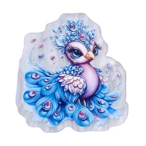 May include: A whimsical, decorative peacock design. The bird features a blue and purple body with a crown and tail feathers adorned with jewels. The image has a pearlescent, iridescent background.