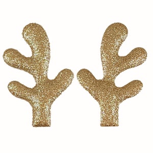 May include: A pair of gold glitter reindeer antlers. The antlers are made of felt and have a sparkly finish.