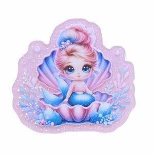May include: A whimsical illustration of a mermaid sitting in a seashell. The mermaid has pink hair and blue eyes, wearing a pink top and blue tail. The seashell is pink and blue, with blue and white accents. The background is a light pink with glitter.