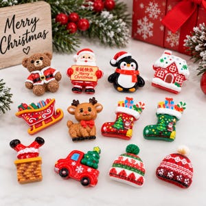 May include: A collection of twelve miniature Christmas-themed resin ornaments including a teddy bear, Santa Claus holding a sign with Chinese text, a penguin, a gingerbread house, a sleigh, a reindeer, two stockings, a chimney, a truck, and two hats.