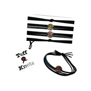 May include: Black elastic bracelets with decorative bronze-colored circular accents. The bracelets are displayed in a stack and individually. The brand name "Tuff Knots" is also visible.