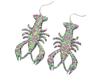 May include: A pair of dangle earrings featuring a green, purple, and gold glitter lobster design.