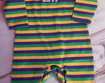May include: A purple, green, and yellow striped long-sleeved baby onesie with the name "Eli" embroidered on the front.