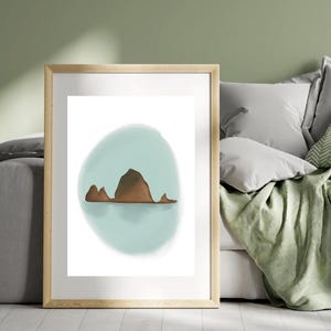 May include: A framed print of a minimalist illustration of a brown mountain range on a light blue background.