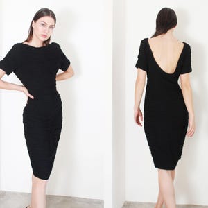May include: A black, short-sleeved dress with a ruched design and a low back.