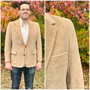 May include: A tan corduroy blazer with a two-button fastening, two front pockets, and a single chest pocket.