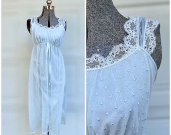 May include: A light blue, sheer nightgown with a lace trim and a gathered waist. The gown has a dotted pattern.