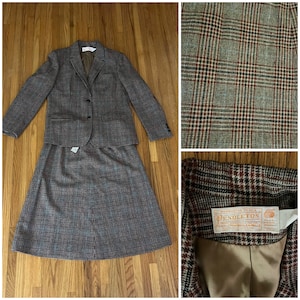 May include: A brown and gray plaid skirt suit with a blazer and a skirt. The blazer has a single button closure and a label that reads "WARRANTED TO BE A PENDLETON WOOLEN MILL PRODUCT."