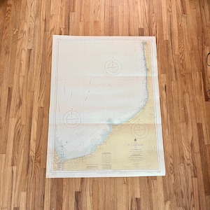 May include: A vintage nautical chart of St. Clair River to Goderich, showing a detailed map of the coastline and waterways. The chart is printed on paper and has a yellowed appearance.