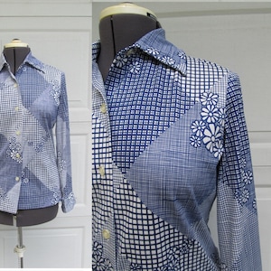 May include: A vintage button-down shirt with a patchwork design in shades of blue and white. The shirt features a mix of geometric patterns, including squares and grids, and floral accents. Long sleeves and a classic collar complete the look.