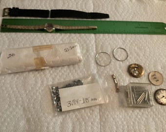 Assorted watch parts items most are used for repair crafts