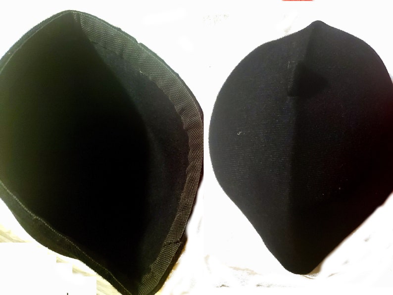 May include: A black fabric hat with a soft, flexible texture. The hat is shown inside out and right side out.