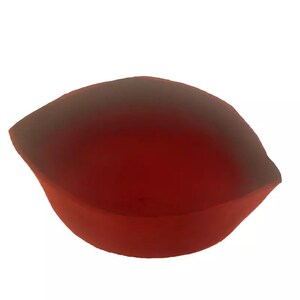 May include: A red, heart-shaped dish with a smooth, glossy finish. The dish is made of a translucent material and has a slight curve to the bottom.