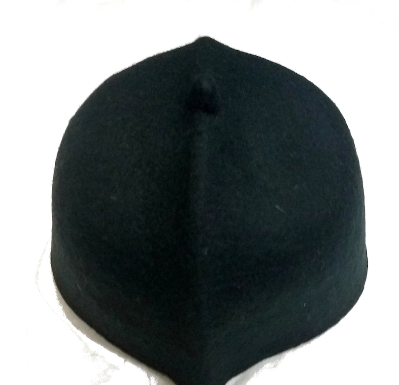 May include: A dark green felt fez hat with a small round top.