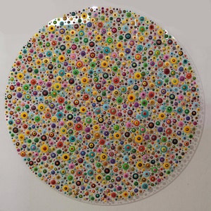 May include: A circular painting with a white background and a pattern of colorful dots. The dots are arranged in a random pattern and are of various sizes. The colors of the dots include red, orange, yellow, green, blue, purple, pink, and black.