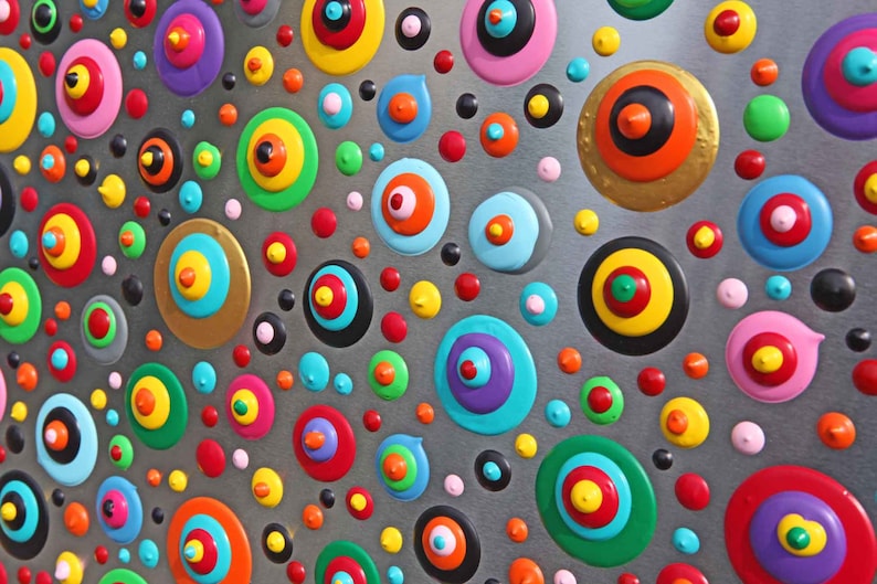 May include: Abstract painting with a silver background and colorful circles with concentric rings. The circles are painted in various colors, including red, blue, green, yellow, and pink.