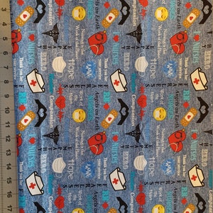 May include: Blue fabric with a repeating pattern of red hearts, white crosses, and a variety of text including "Angels on Earth", "Work of the Heart", "Nursing is the Work of the Heart", "Hope", "Compassion", "Hero", "Nurses", "Thank you for your service", and "Fearless".