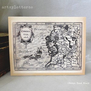 May include: A vintage black and white map of Ireland from 1616. The map is titled "CONNA TIA. 1616." and shows the coastline of Ireland with various towns and cities labeled. The map is surrounded by a decorative border.
