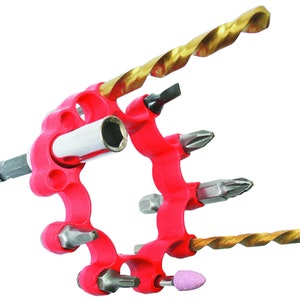 May include: A red plastic tool holder with a variety of drill bits and screwdriver bits. The holder has a circular shape and is designed to hold the bits securely in place.