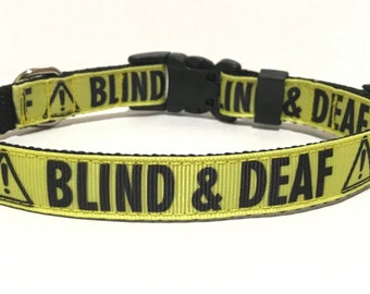 May include: Yellow dog collar with black text that reads "BLIND & DEAF" with a black exclamation point inside a yellow triangle on either side of the text.