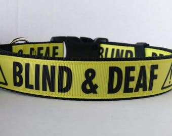 May include: Yellow and black dog collar with the text "BLIND & DEAF" in black letters.
