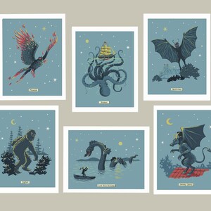 May include: Six illustrated cards featuring mythical creatures against a blue starry night sky. The cards feature a Phoenix, Kraken, Mothman, Yeti, Loch Ness Monster, and Jersey Devil.