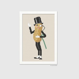 May include: A cross-stitch pattern of a peanut character wearing a top hat, monocle, and a tuxedo. The peanut is standing with one hand raised and the other on a cane. The background is a light beige.