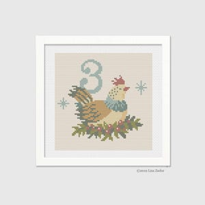May include: Cross stitch pattern featuring a stylized bird with a red comb and a blue scarf, perched on a branch with red berries. The number "3" is in the background. The pattern is titled "2019 Lisa Zador".