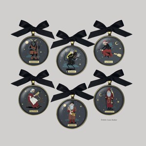 May include: Six round ornaments with black ribbon bows, each featuring a different mythical creature. The ornaments are gold with a dark blue background and depict Krampus, Befana,  Belsnickel,  Knecht Ruprecht,  Frau Perchta, and  Rottmannndl.