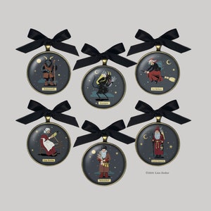 May include: Six round ornaments with black ribbon bows and gold trim. Each ornament features a different mythical creature, including Krampus, Befana, and the Yule Goat. The ornaments are decorated with stars and moons. The text "&copy;2021 Lisa Zador" appears at the bottom of the image.