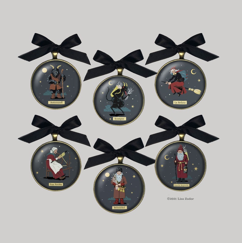 May include: Six round ornaments with black ribbon bows and gold trim. Each ornament features a different mythical creature, including Krampus, Befana, and the Yule Goat. The ornaments are decorated with stars and moons. The text "&copy;2021 Lisa Zador" appears at the bottom of the image.