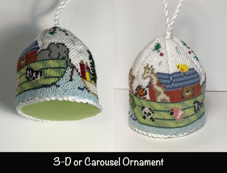 May include: A 3-D or Carousel ornament featuring a white fabric base with a colorful embroidered scene of animals on a boat. The ornament has a green felt bottom and a white cord for hanging.